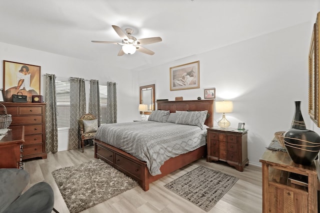 bedroom featuring baseboards, ceiling fan, and light wood finished floors