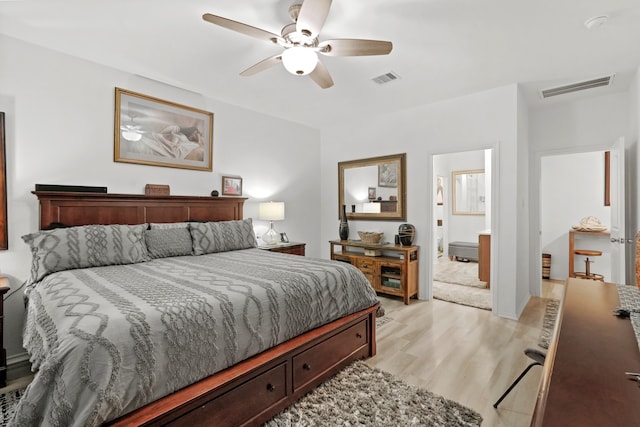 bedroom with ensuite bath, light wood-type flooring, and ceiling fan