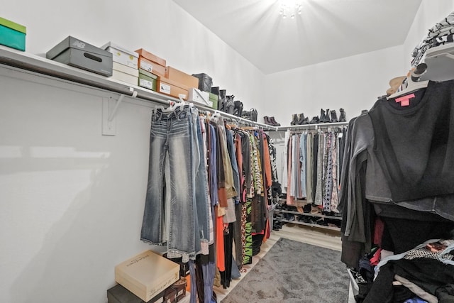 walk in closet with wood finished floors