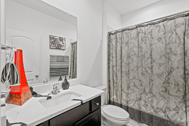 bathroom featuring vanity, toilet, and curtained shower