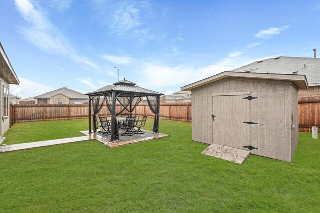 view of yard featuring a storage shed, a patio area, and a gazebo