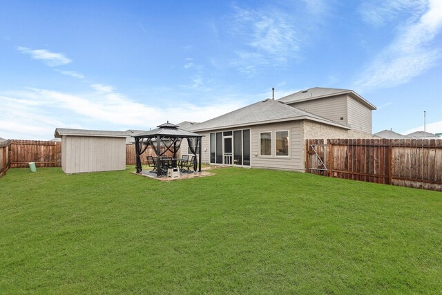 rear view of house with a storage shed, a patio area, a lawn, and a gazebo