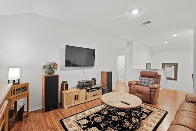 living room with lofted ceiling, recessed lighting, light wood-style floors, and visible vents