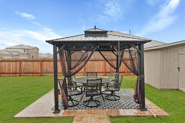 view of patio with a storage unit and a gazebo