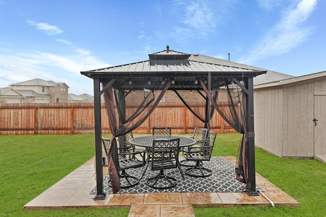 view of patio / terrace featuring a gazebo, outdoor dining area, and fence