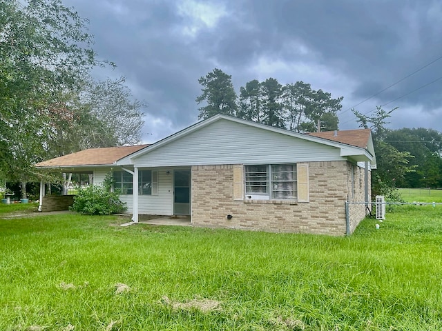 view of front of house featuring a front yard and central air condition unit