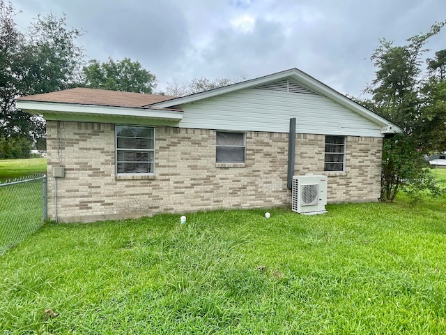 view of home's exterior featuring a lawn and ac unit