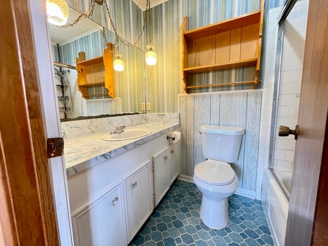 full bathroom featuring vanity, combined bath / shower with glass door, and toilet