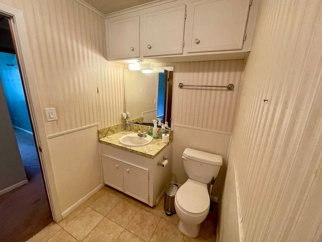 bathroom featuring vanity, toilet, and tile patterned flooring