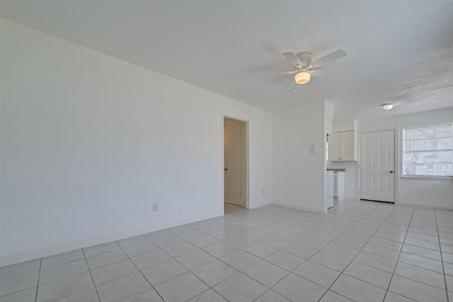 unfurnished room with ceiling fan and light tile patterned floors