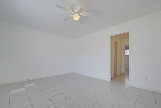 empty room featuring ceiling fan and light tile patterned floors