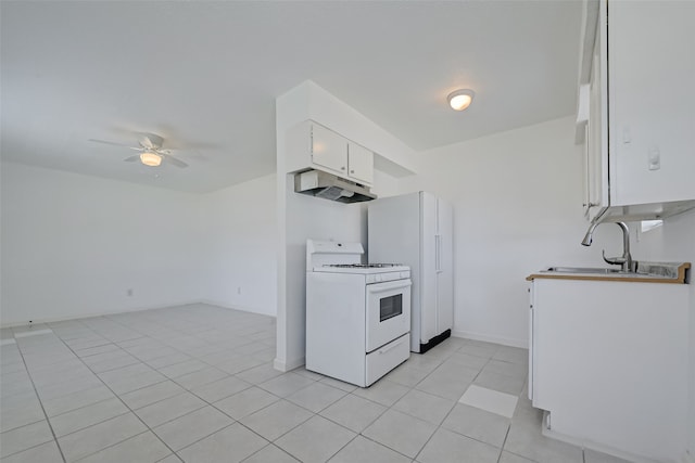 kitchen with white range oven, white cabinetry, light tile patterned floors, ceiling fan, and sink