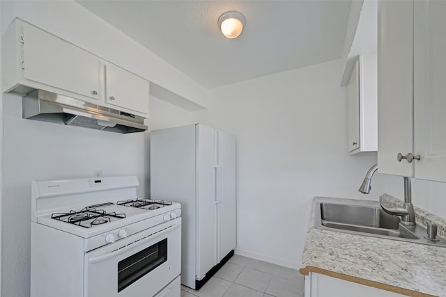 kitchen featuring white appliances, white cabinetry, sink, and light tile patterned floors