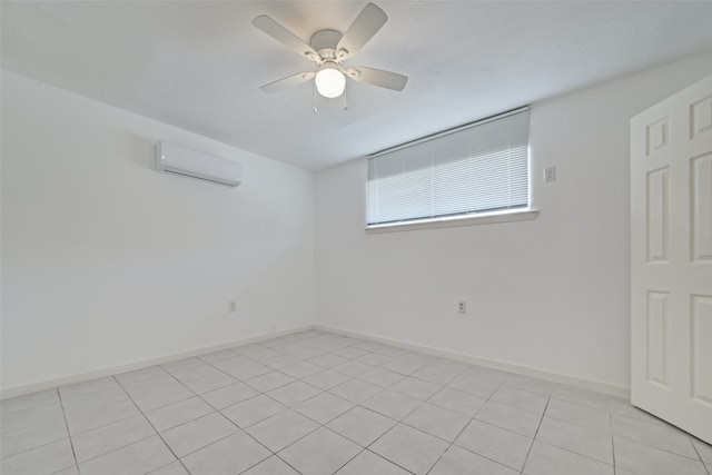 unfurnished room with ceiling fan, light tile patterned floors, and a wall mounted air conditioner