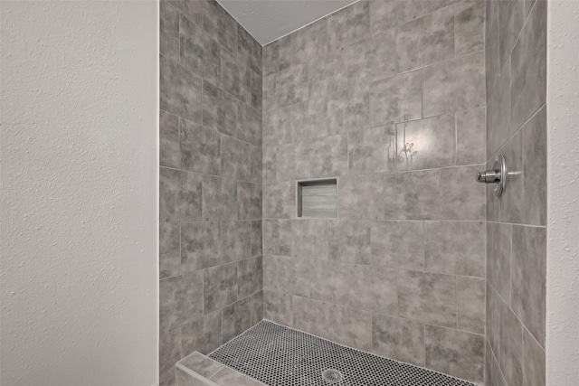 bathroom featuring a tile shower