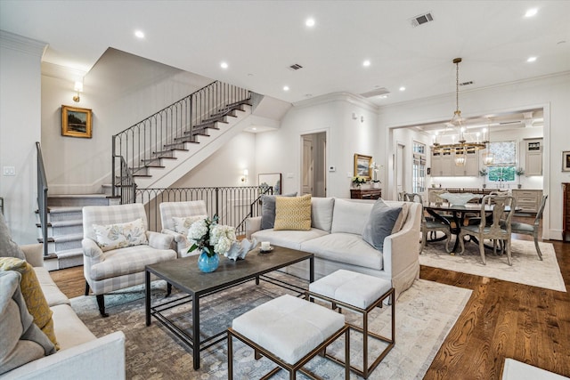 living room featuring dark wood-style floors, ornamental molding, and recessed lighting