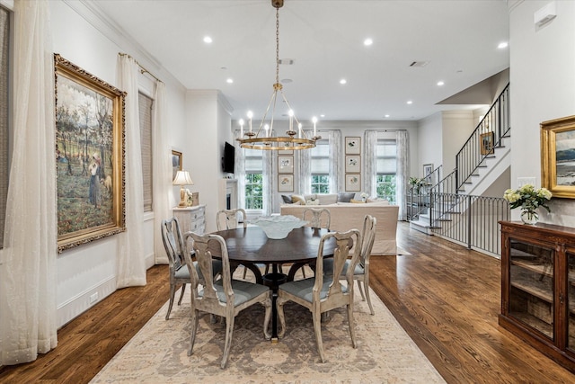 dining area featuring crown molding, recessed lighting, stairway, wood finished floors, and a chandelier