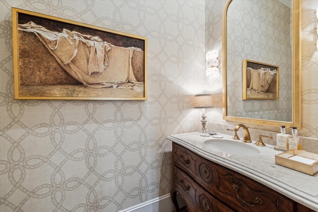 bathroom featuring vanity and wallpapered walls