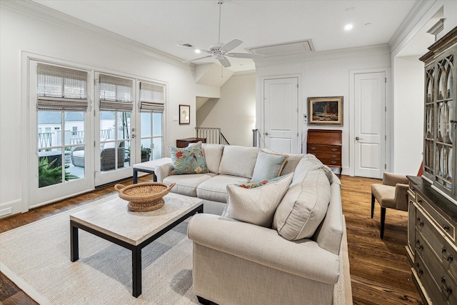 living room with attic access, visible vents, dark wood-style flooring, crown molding, and recessed lighting