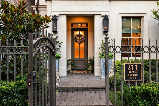 doorway to property featuring a gate and fence