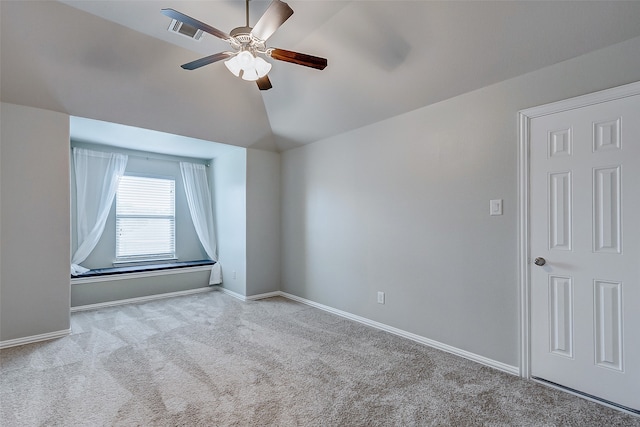 empty room featuring light carpet, lofted ceiling, and ceiling fan