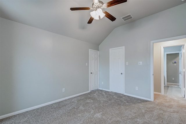 unfurnished bedroom with light carpet, vaulted ceiling, and ceiling fan