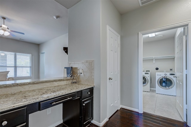 kitchen featuring independent washer and dryer, hardwood / wood-style flooring, light stone counters, and ceiling fan