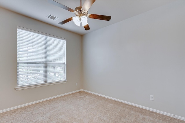 unfurnished room featuring visible vents, light carpet, baseboards, and ceiling fan