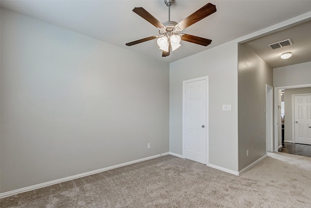 unfurnished bedroom with visible vents, carpet floors, baseboards, and ceiling fan