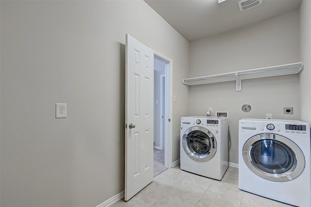 clothes washing area featuring visible vents, baseboards, washer and clothes dryer, laundry area, and light tile patterned flooring