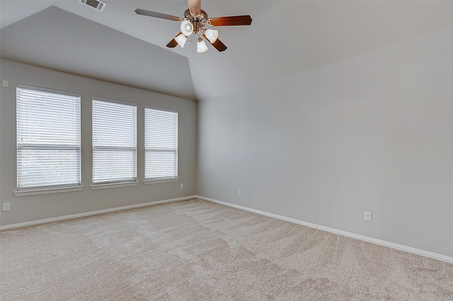 unfurnished room featuring visible vents, baseboards, light colored carpet, vaulted ceiling, and a ceiling fan