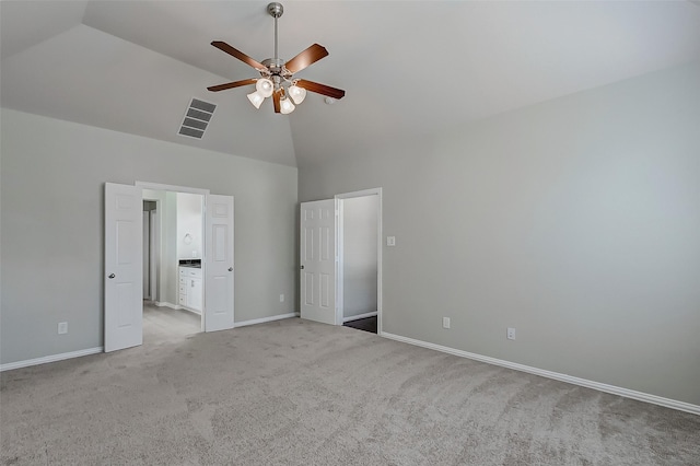 unfurnished bedroom with carpet, visible vents, baseboards, high vaulted ceiling, and connected bathroom