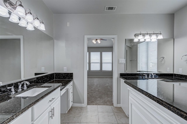 bathroom featuring tile patterned flooring, two vanities, visible vents, and a sink