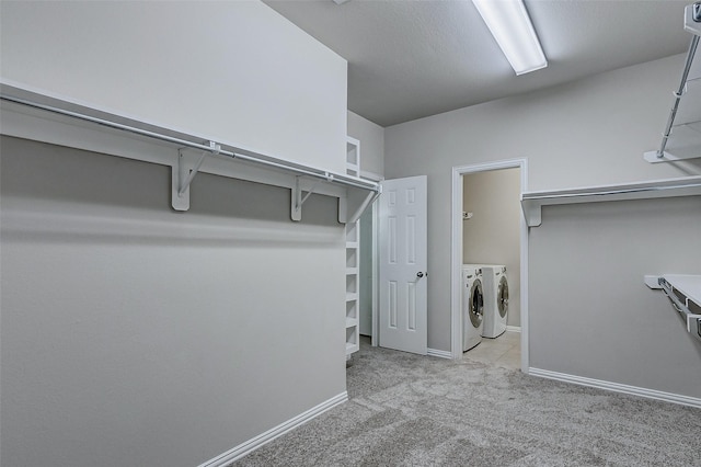 walk in closet with washer and dryer and carpet floors