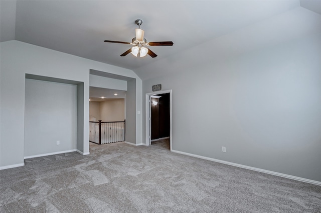 unfurnished bedroom featuring light carpet, lofted ceiling, and ceiling fan