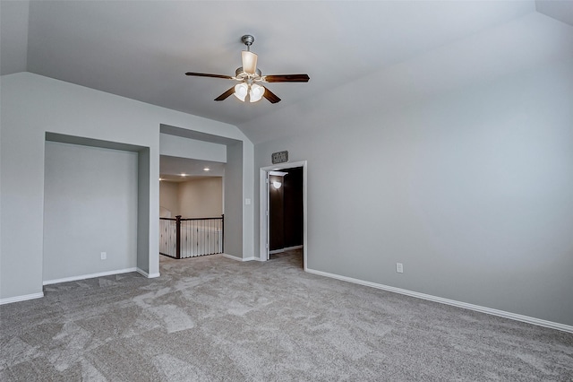 unfurnished bedroom featuring baseboards, lofted ceiling, and carpet floors