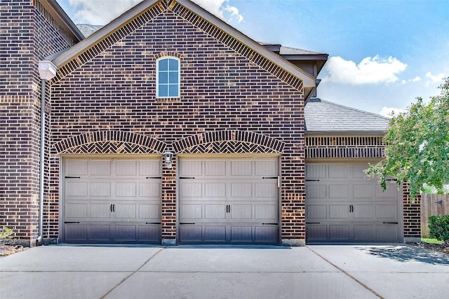 garage with concrete driveway