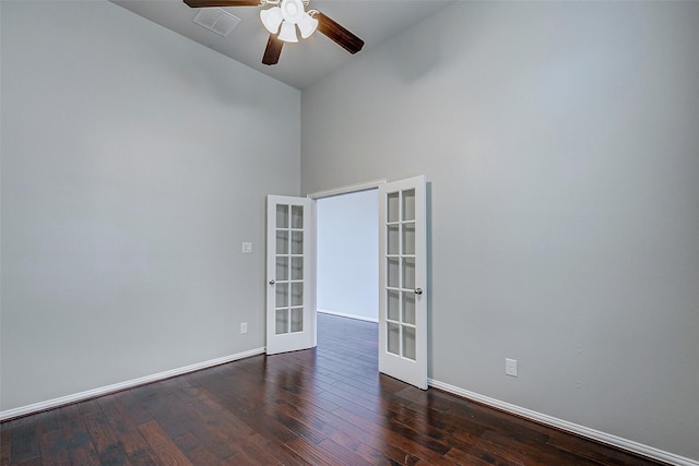 unfurnished room featuring visible vents, baseboards, dark wood-style flooring, ceiling fan, and french doors