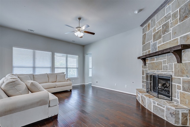 living room featuring a fireplace, ceiling fan, and dark hardwood / wood-style floors