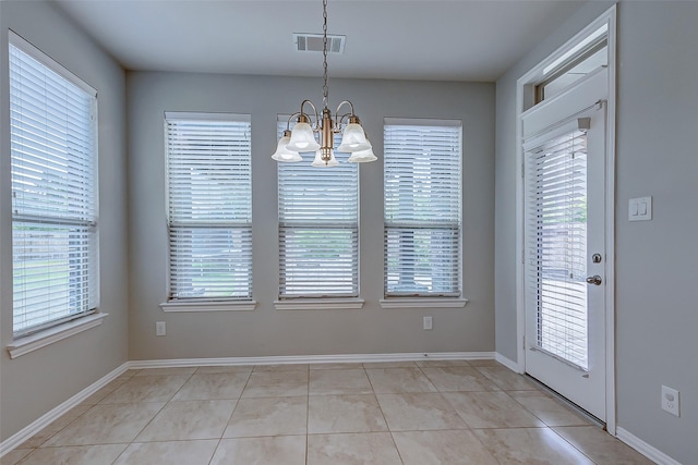 unfurnished dining area featuring a wealth of natural light, visible vents, a chandelier, and light tile patterned floors