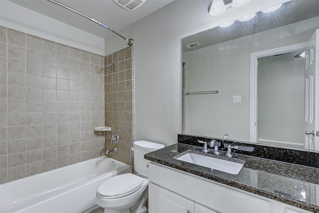 bathroom featuring vanity, toilet, washtub / shower combination, and visible vents