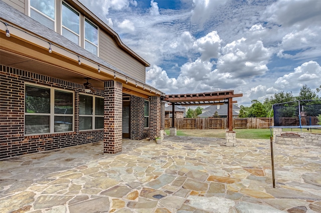 view of patio / terrace featuring a trampoline and a pergola