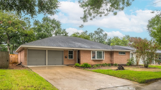 ranch-style house featuring a garage and a front yard