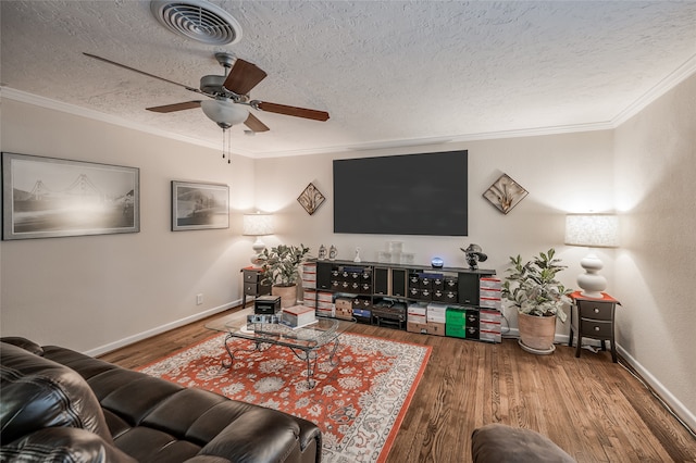 living room with ceiling fan, dark hardwood / wood-style flooring, a textured ceiling, and ornamental molding