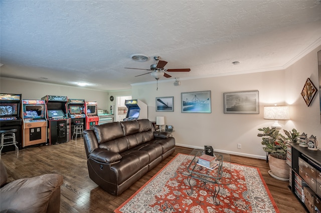 living room with a textured ceiling, ceiling fan, dark hardwood / wood-style floors, and ornamental molding