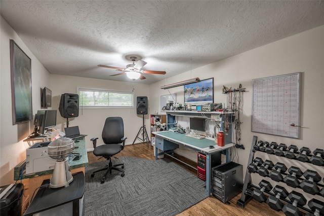 office space featuring a textured ceiling, ceiling fan, and hardwood / wood-style flooring