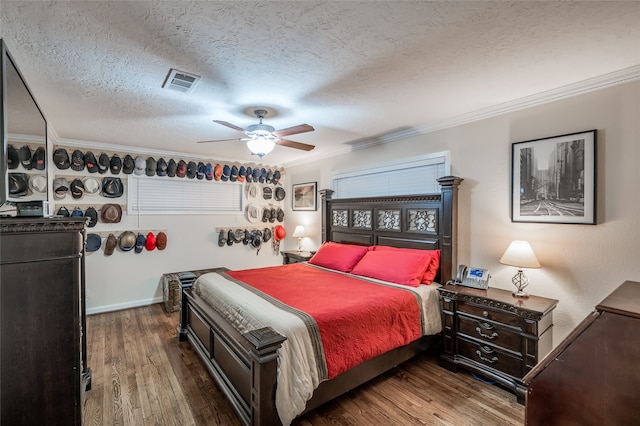 bedroom featuring a textured ceiling, ceiling fan, ornamental molding, and dark hardwood / wood-style flooring