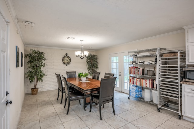 tiled dining area featuring a textured ceiling, ornamental molding, a chandelier, and french doors