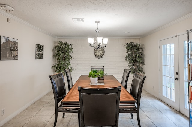 tiled dining space featuring french doors, a textured ceiling, and a healthy amount of sunlight