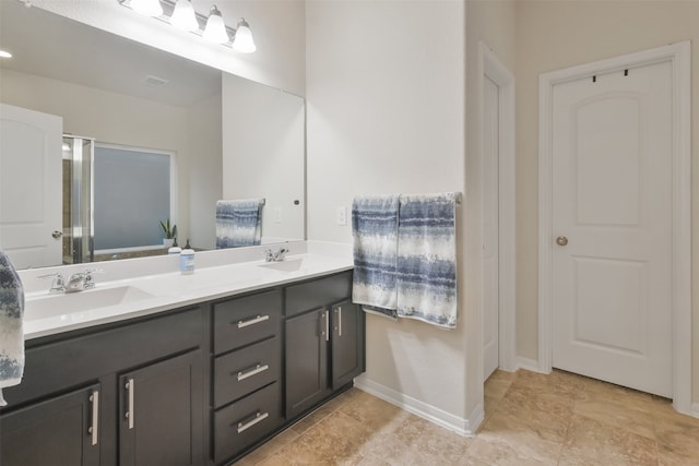 bathroom with a shower with door and vanity